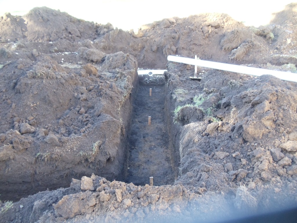 Drain line trench ready for drain rock and pipe installation